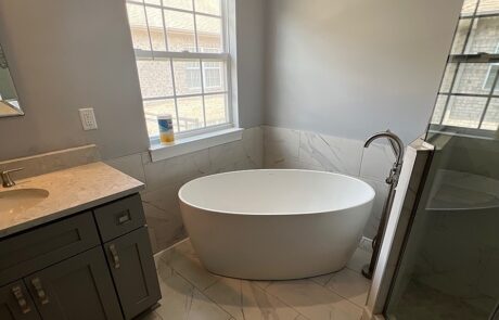 Tile bathroom with white bathtub